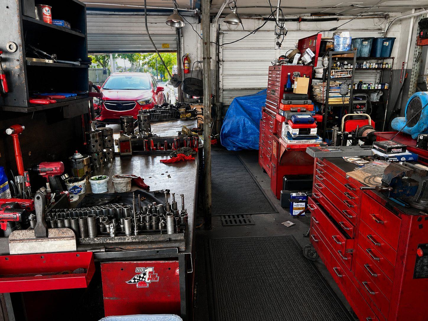 Shop bay with red toolboxes and a workbench of sockets