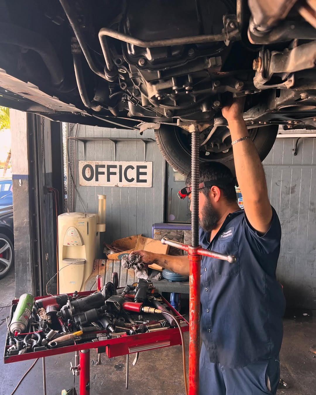 Technician working under a car in the shop